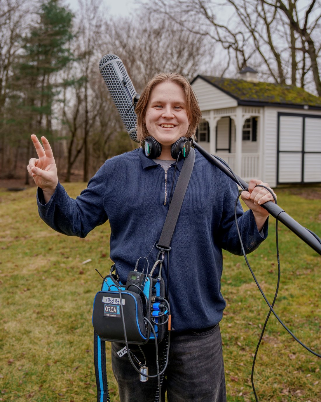 Declan Joyce on set with a boom microphone and sound bag