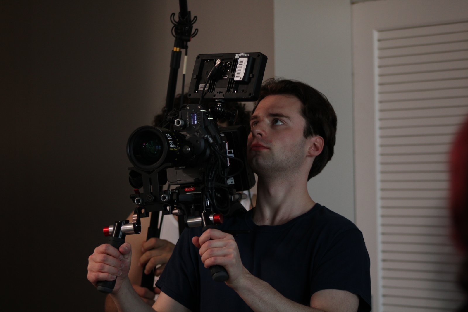 Michael Egan operating a camera on a shoulder rig